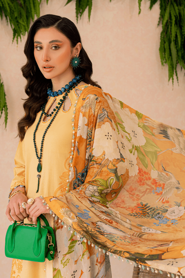 a woman in a yellow dress holding a green purse.